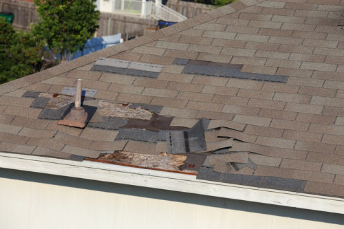residential roof with damaged shingles